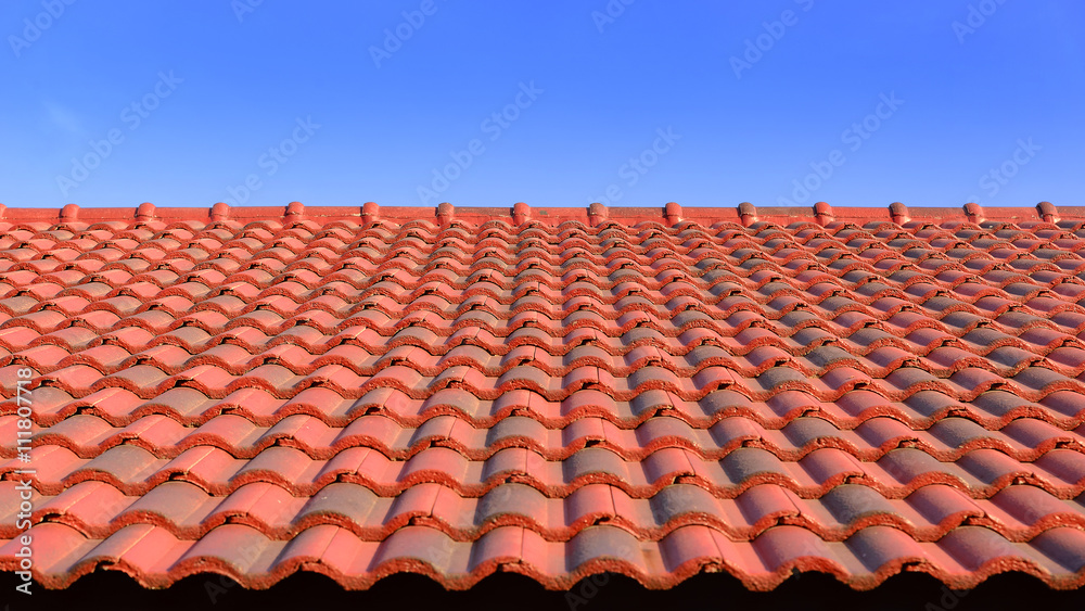 the red ceramic roof tile with sun light and blue sky the red ceramic roof tile with sun light and blue sky