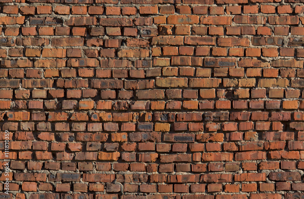 Seamless red brick wall rexture. Old bricks grunge tileable background.