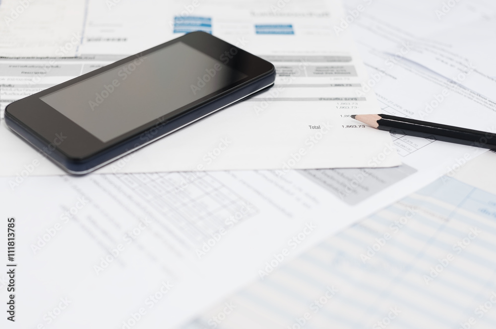 Utility Bill and smart phone calculating concept Utility Bill and smart phone calculating concept