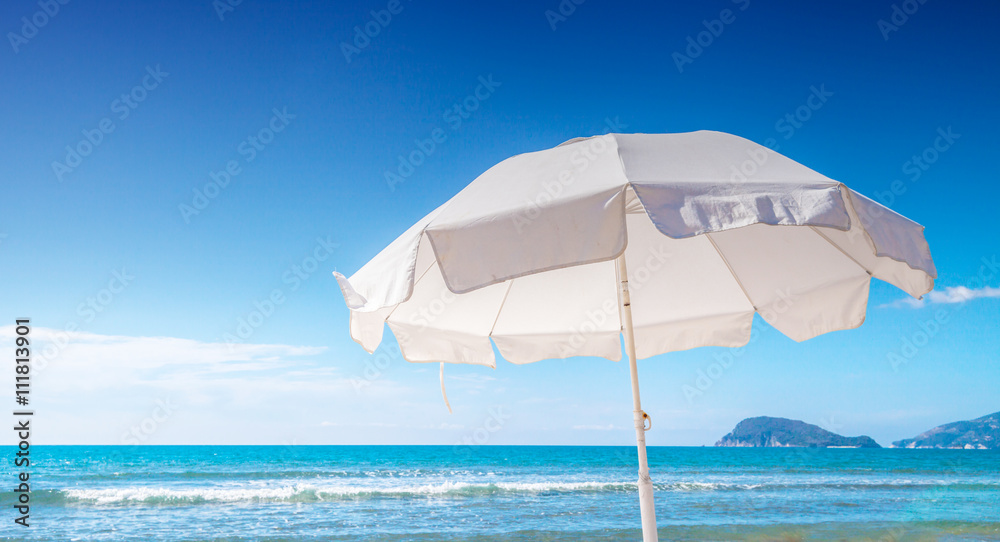 Umbrella on tropical beach hot summer day