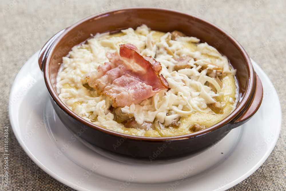 banosh with cheese and bacon in a clay bowl banosh with cheese and bacon in a clay bowl