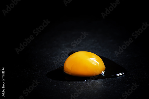 Broken egg, black background, selective focus