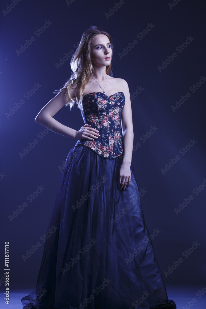 Portrait of a woman in a beautiful dress with a floral pattern in the Studio Portrait of a woman in a beautiful dress with a floral pattern in the Studio