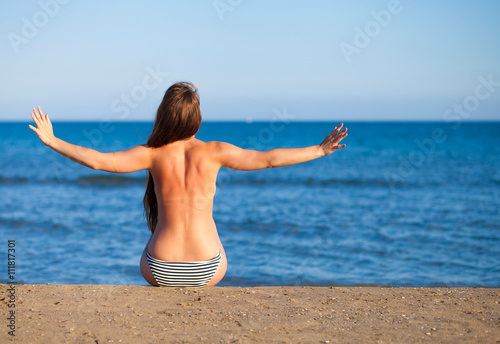 Woman on the beach during summer vacation enjoying hot sun © leszekglasner