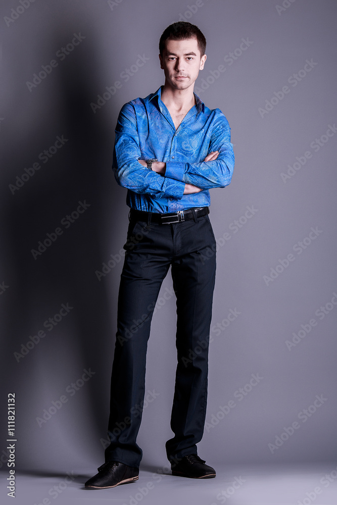 Portrait of handsome man in blue sweater on a dark background in the Studio Portrait of handsome man in blue sweater on a dark background in the Studio