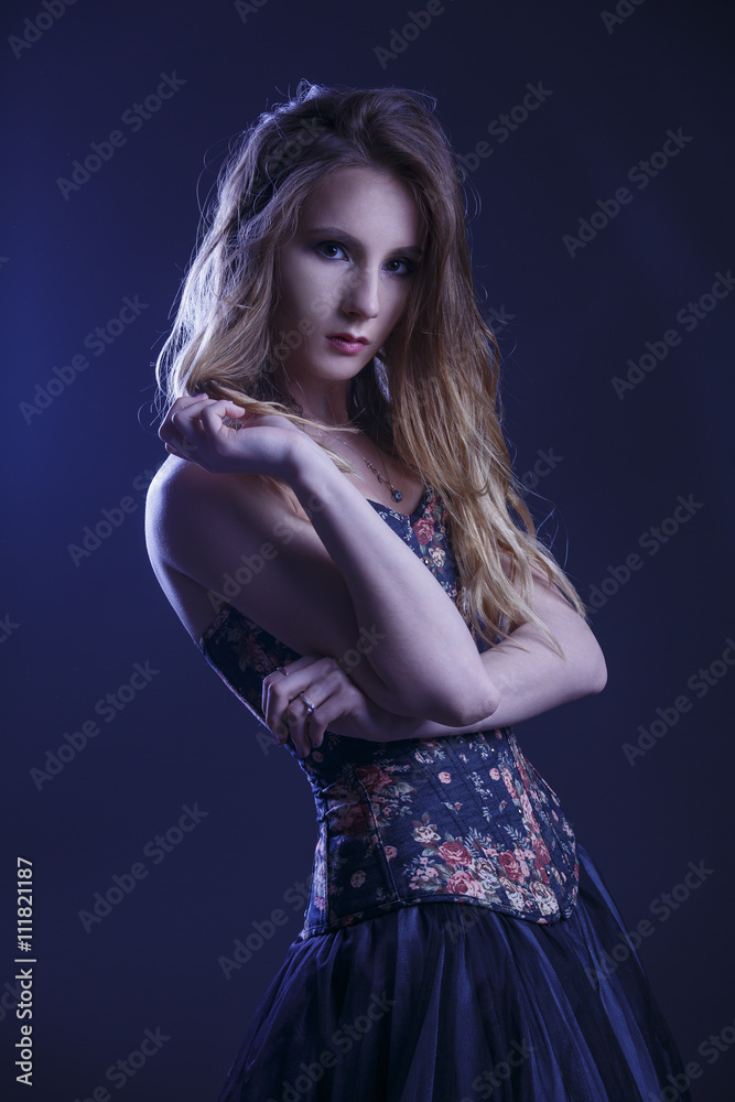 Portrait of a woman in a beautiful dress with a floral pattern in the Studio Portrait of a woman in a beautiful dress with a floral pattern in the Studio