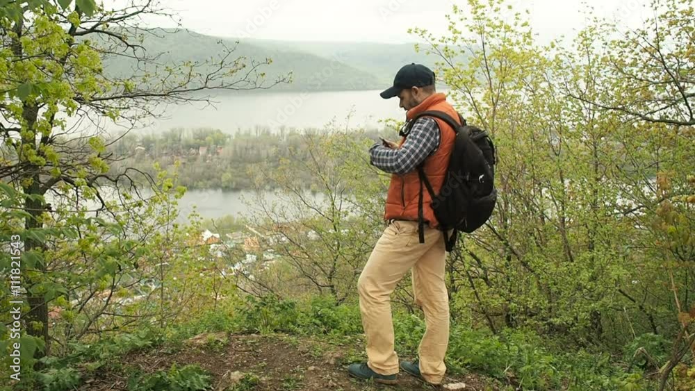 man with a backpack photographed on a smartphone natural landscape man with a backpack photographed on a smartphone natural landscape