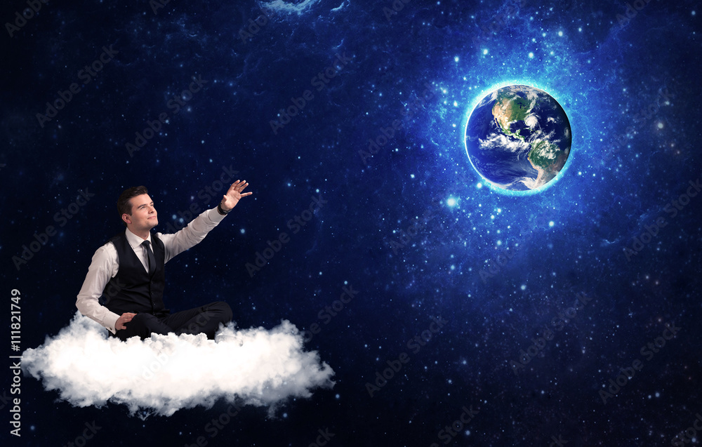 Obraz premium Man sitting on cloud looking at planet earth
