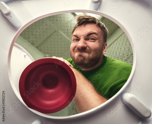 Man with cup plunger photo