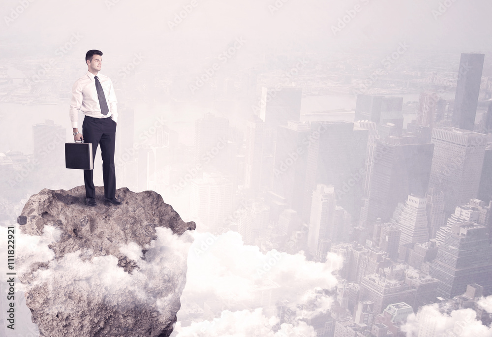Winner business person standing on rock Winner business person standing on rock