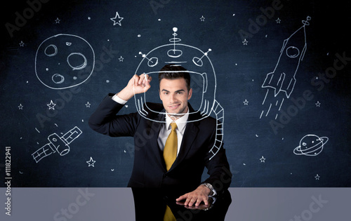 Sales person drawing helmet and space rocket