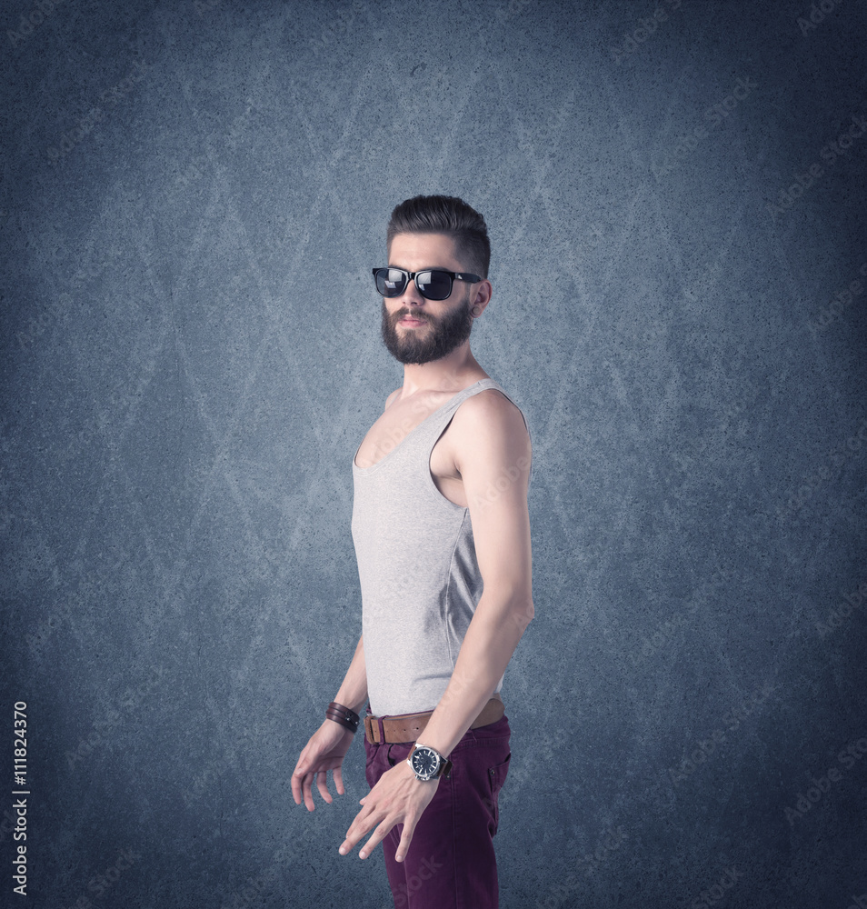 Bearded hipster standing in elegant clothes