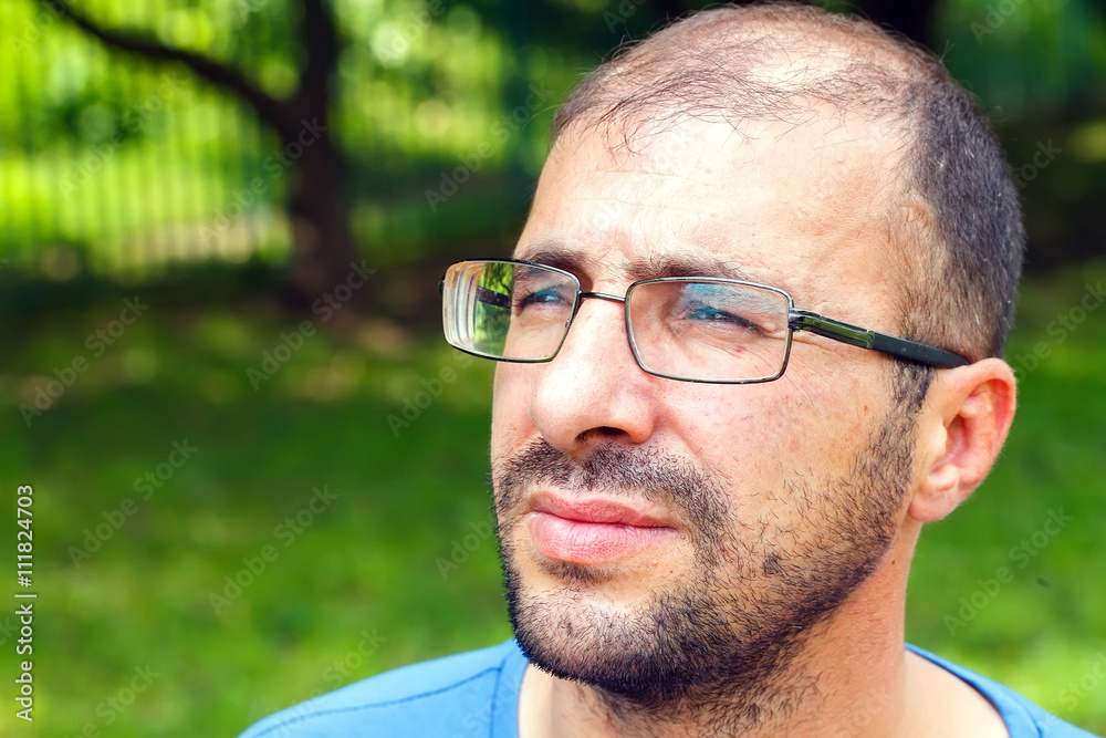 portrait of young man with bad eyesight and hair loss. portrait of young man with bad eyesight and hair loss.