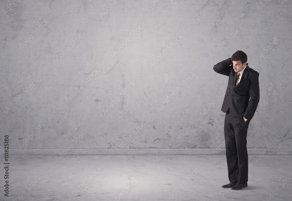 Young businessman standing confused