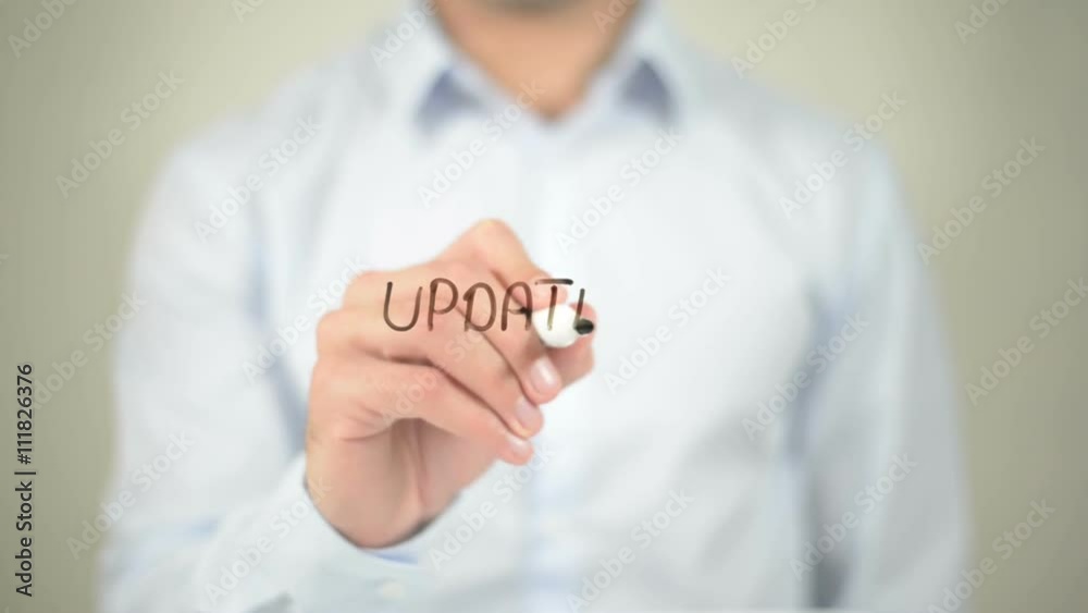 Updates , man writing on transparent screen Updates , man writing on transparent screen