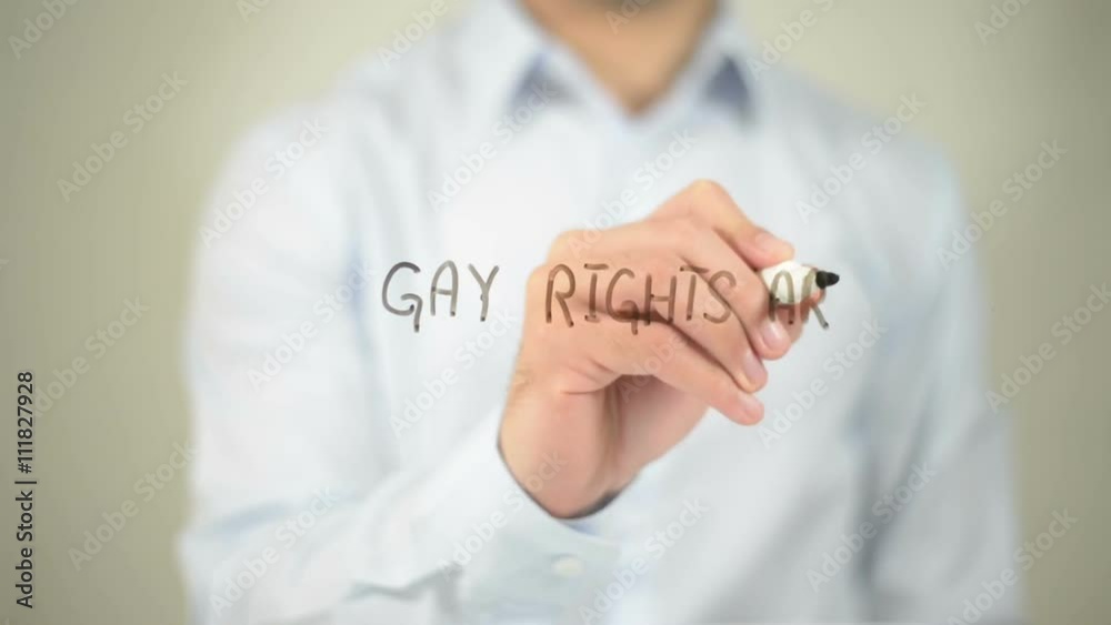 Gay Rights Are Human Rights , man writing on transparent screen Gay Rights Are Human Rights , man writing on transparent screen