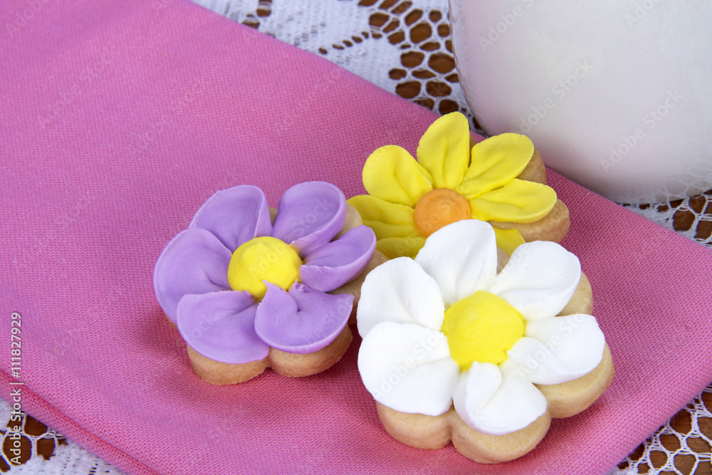 Home made designer Flower Sugar cookies on pink napkin Home made designer Flower Sugar cookies on pink napkin