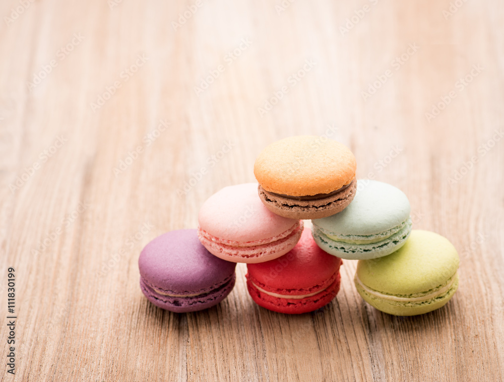 Colorful French Macarons on wooden background Colorful French Macarons on wooden background