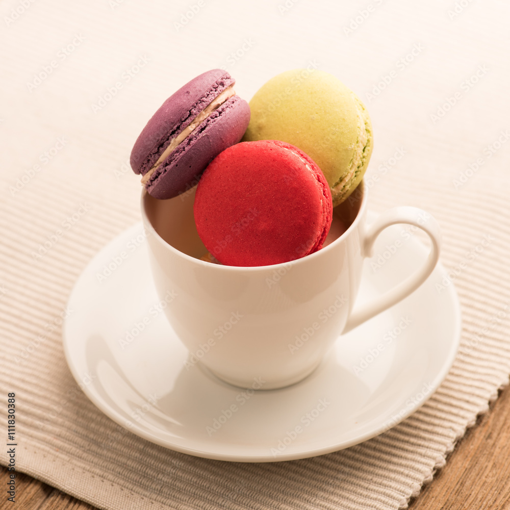 A lot of french colorful macarons on a woody floor,macarons in a A lot of french colorful macarons on a woody floor,macarons in a