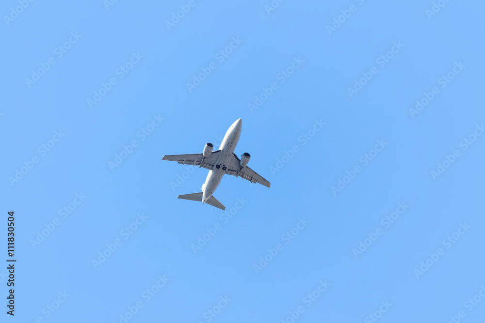 One airplane taking off on blue sky background One airplane taking off on blue sky background