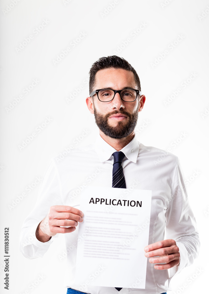 office worker with glasses showing an application form office worker with glasses showing an application form