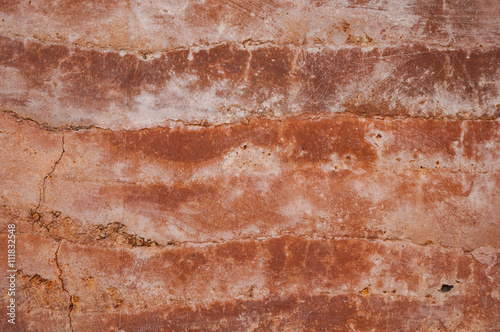 Rammed earth wall with different shades of orange soil