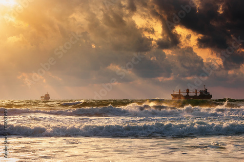Cargo ship with containers in sunrise light © ValentinValkov