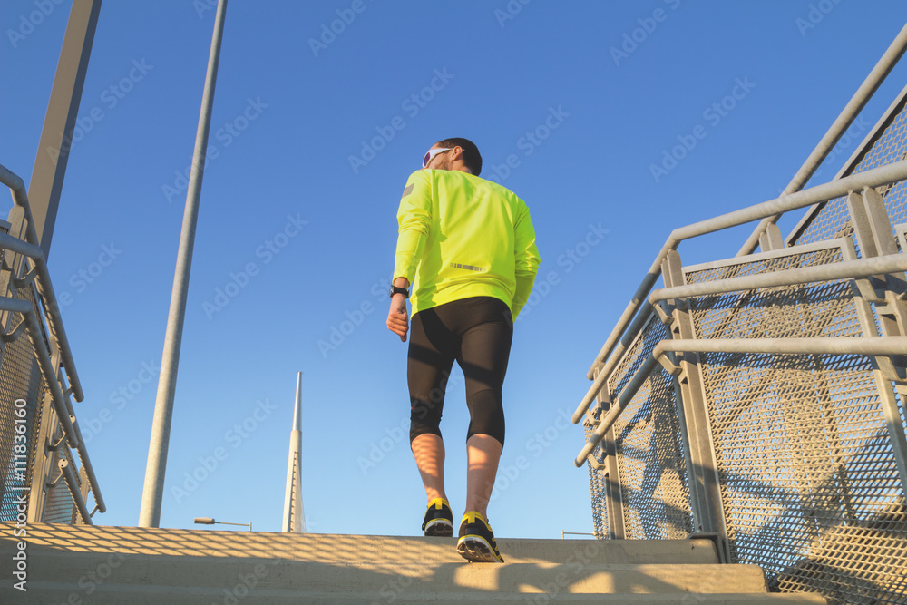 Urban jogger on a big staircase of a bridge. Urban jogger on a big staircase of a bridge.