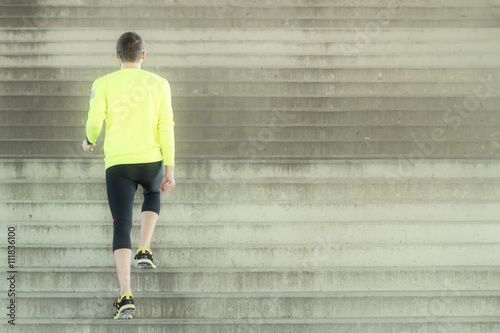 Urban jogger exercising on a big staircase.