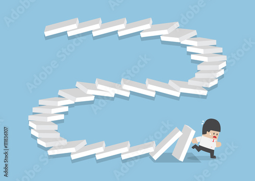 Businessman escaping from falling dominos