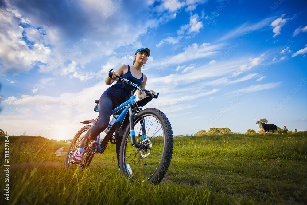 woman cyclist rides in the forest on a mountain bike.