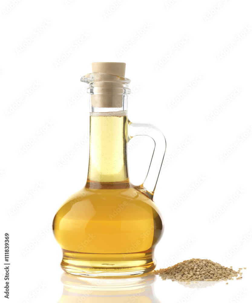 Sesame Oil / High resolution image of sesame oil decanter with sesame seeds shot in studio on white background Sesame Oil / High resolution image of sesame oil decanter with sesame seeds shot in studio on white background