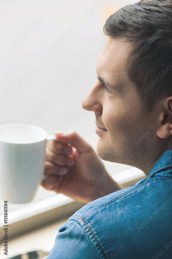 Cheerful young guy is enjoying the morning Cheerful young guy is enjoying the morning