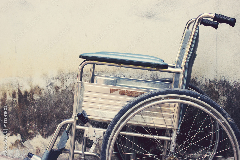 Vintage,Old Wheelchairs with wall background