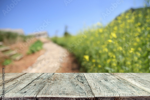 Wooden desk space platform on farm of field background