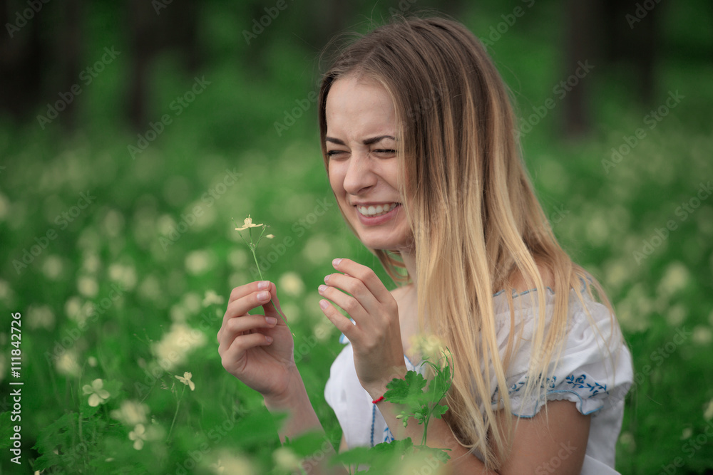 Beautiful young girl close-up in a white shirt, against a background of green forest Beautiful young girl close-up in a white shirt, against a background of green forest