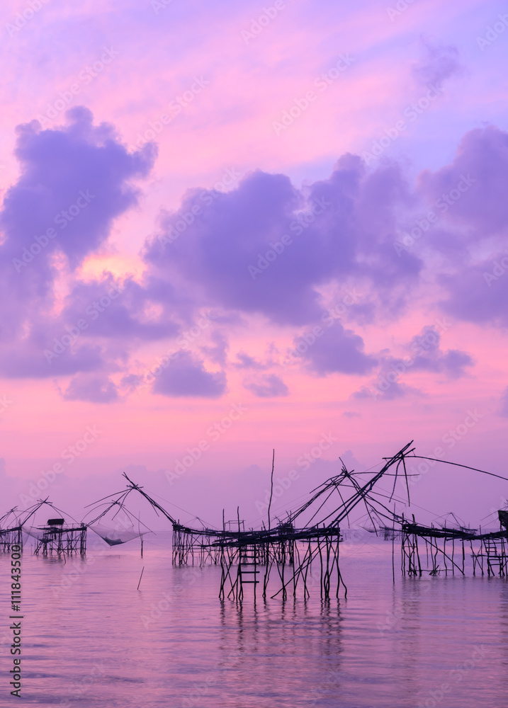 Beautiful sunrise seascape with Chinese fishing nets or shore operated lift nets in Phatthalung, Thailand