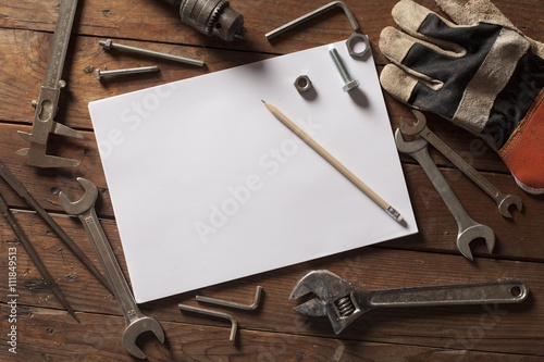 Tools on the wood background with Blank sketchbook mockup