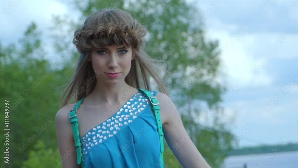 young beautiful girl walks along the promenade young beautiful girl walks along the promenade