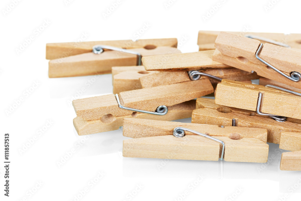 Wooden clothespins close-up isolated on white.