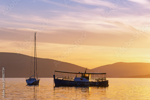 Silhouettes of two boats at sunset. Bay of Kotor, Montenegro