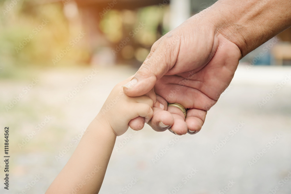 Father and son holding hands together. Father and son holding hands together.