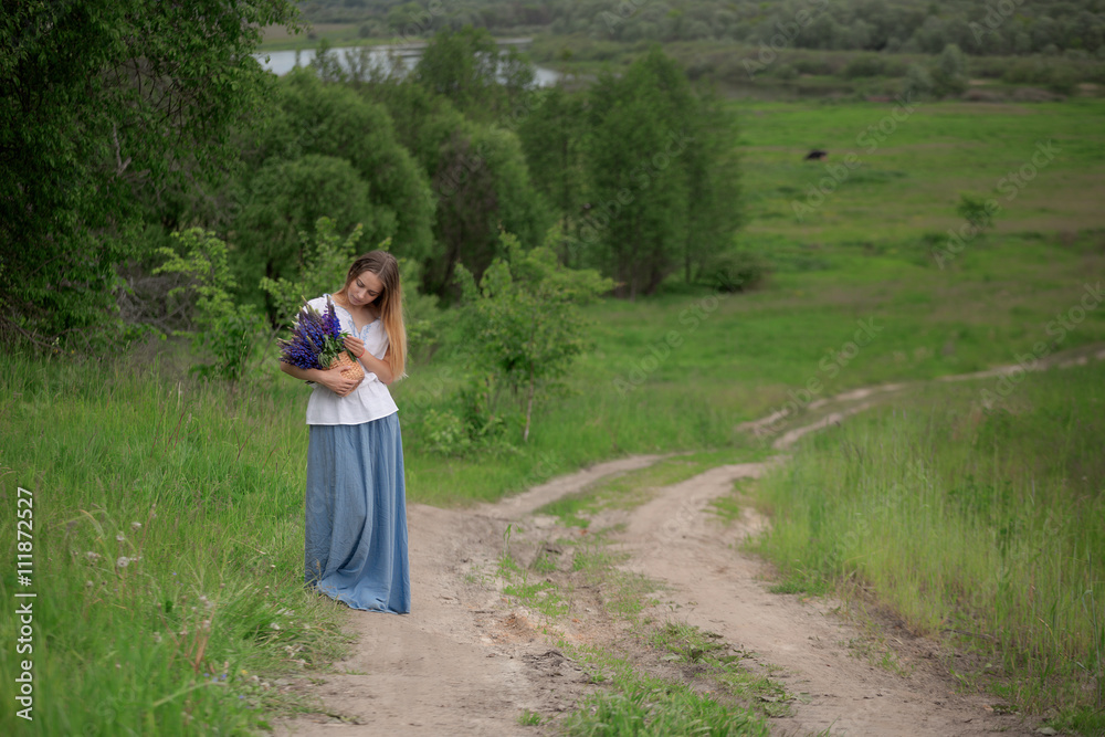 Portrait of beautiful young woman with flowers in the field Portrait of beautiful young woman with flowers in the field