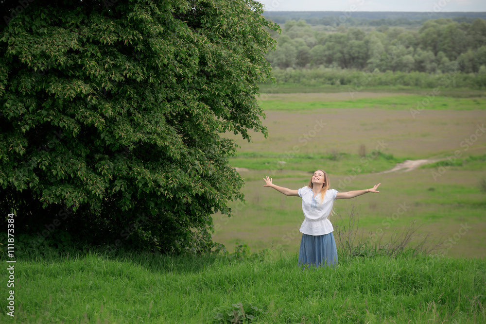 Portrait of beautiful young woman with flowers in the field Portrait of beautiful young woman with flowers in the field