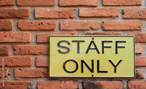 Staff only sign on yellow metal board
