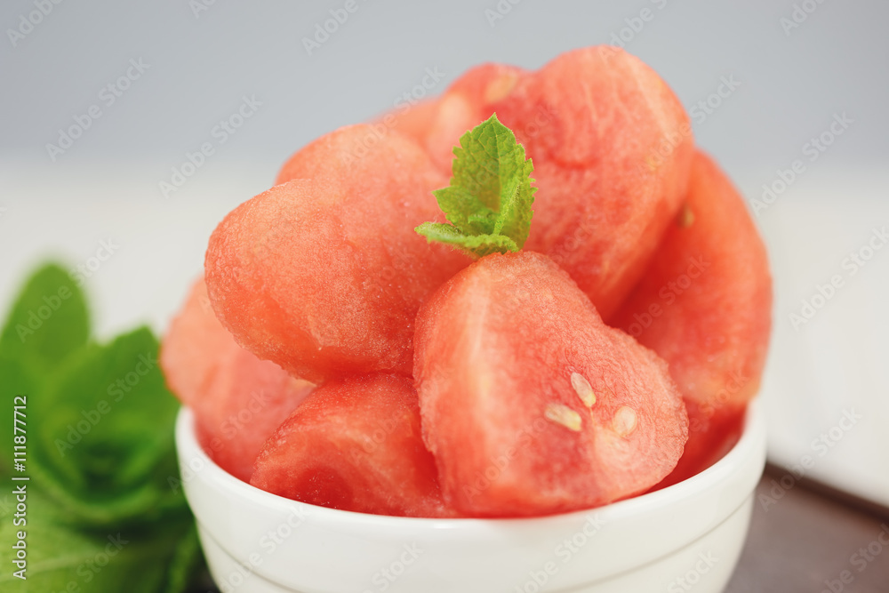 White bowl full of red hearts from the watermelon. White bowl full of red hearts from the watermelon.