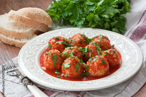 Meatballs with tomato sauce / Delicious homemade chicken or turkey meatballs with rice, vegetable and tomato sauce photo