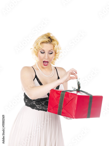 woman with mouth open opening her christmas present.