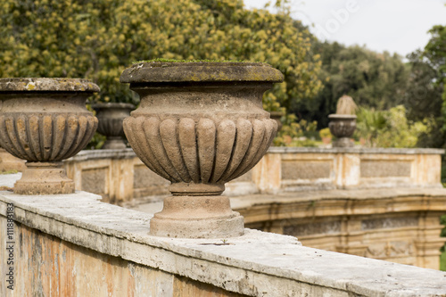 series of terracotta pots at a public park in Rome, focus on first.