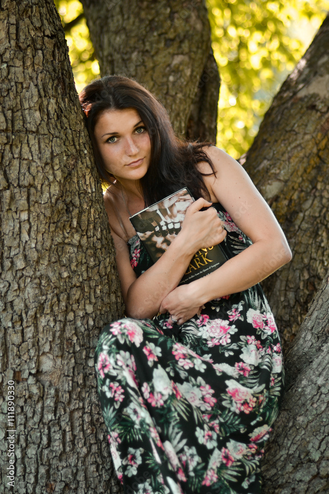 Beautiful,cute,attractive,relaxed,calm,clever,smart girl hug a book.Gorgeous girl read the book,sit on the tree.Fairy tale.Girl cuddle up interesting book in cozy warm atmosphere.Lovely girl with book Beautiful,cute,attractive,relaxed,calm,clever,smart girl hug a book.Gorgeous girl read the book,sit on the tree.Fairy tale.Girl cuddle up interesting book in cozy warm atmosphere.Lovely girl with book